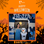 Two people in "Frozen" costumes posing in front of a themed backdrop. The scene is set for Halloween with an orange border featuring spider webs, bats, and the text "Happy Halloween.