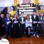 A group of seven people in formal attire pose for a photo holding certificates at a 10th-anniversary event with a "Unmasking a Decade of Excellence" theme.