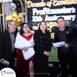 Four individuals dressed in formal attire hold envelopes and stand in front of a backdrop at an event celebrating Profitmaster's 10th anniversary.